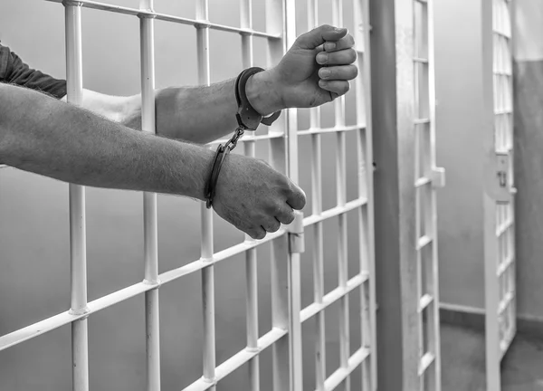 depositphotos 29992139 stock photo prisoner in handcuffs locked in